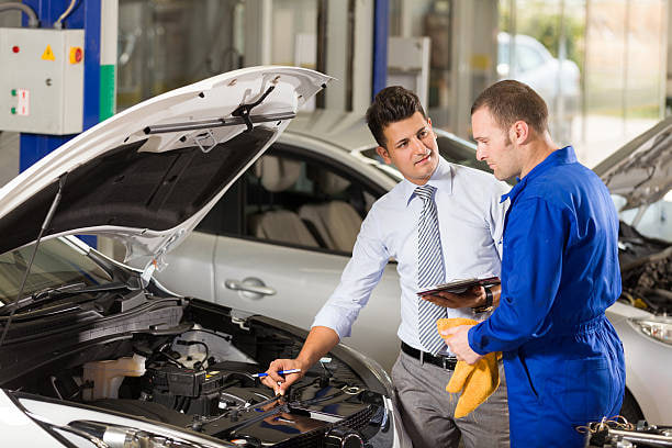 Mechanic explaining car issues to a customer with a transparent estimate